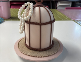 Bird cage cake with pearls, flowers and leaves